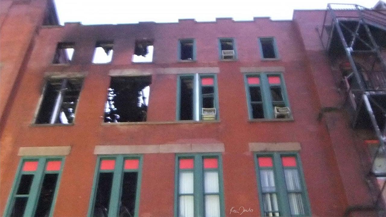 Brick Building with Red and Green Windows